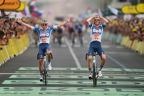 Romain Bardet, right, crosses the finish line with teammate Netherlands' Frank van den Broek